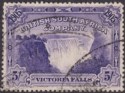 Click for more photos and details Rhodesia 1905 KEVII BSAC Victoria Falls 5sh Violet Fiscally Used SG99